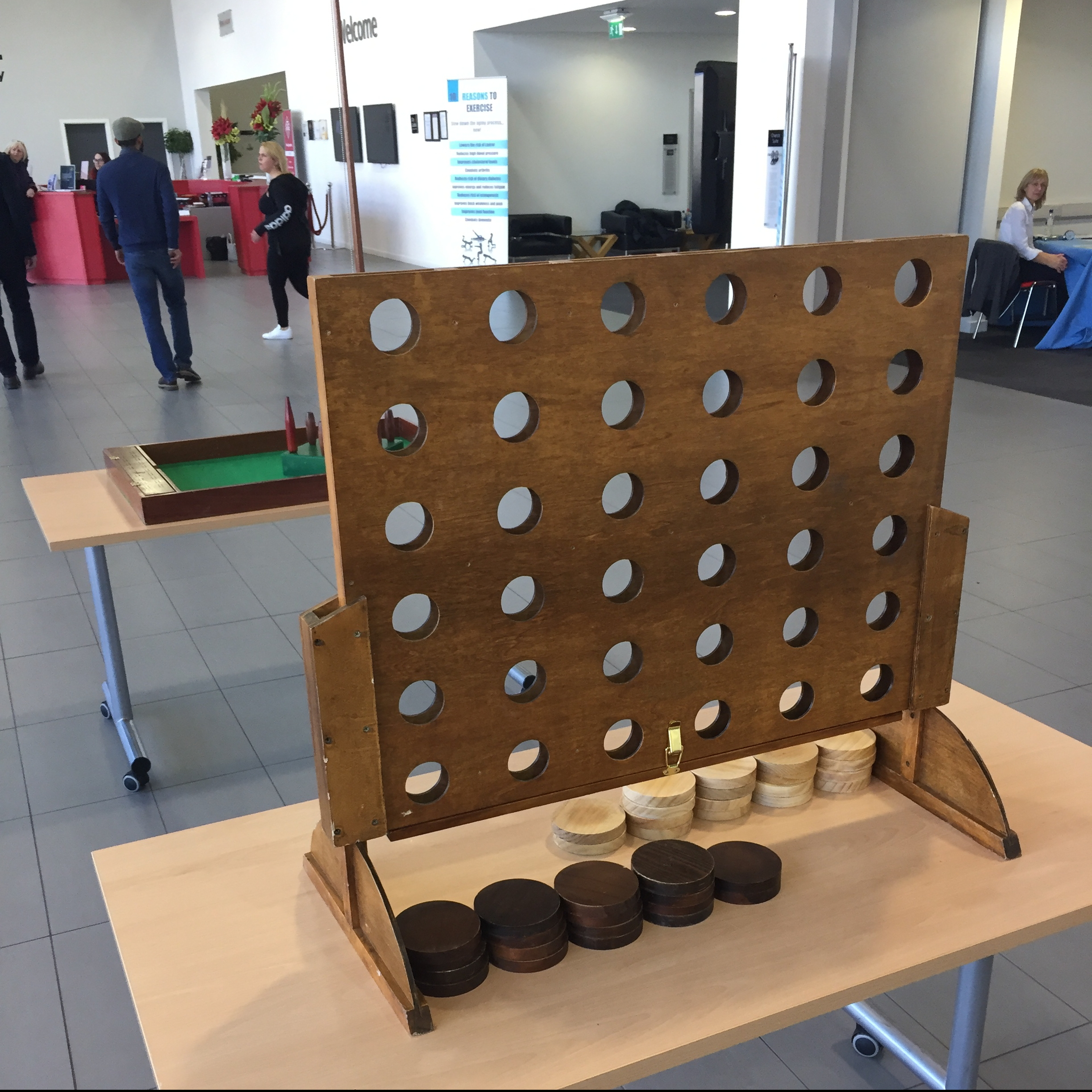 A wooden traditional Score 4 sized perfectly for a table-top position at an indoor event.