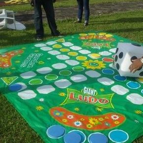 Giant Ludo being played at a family Garden Birthday Party.