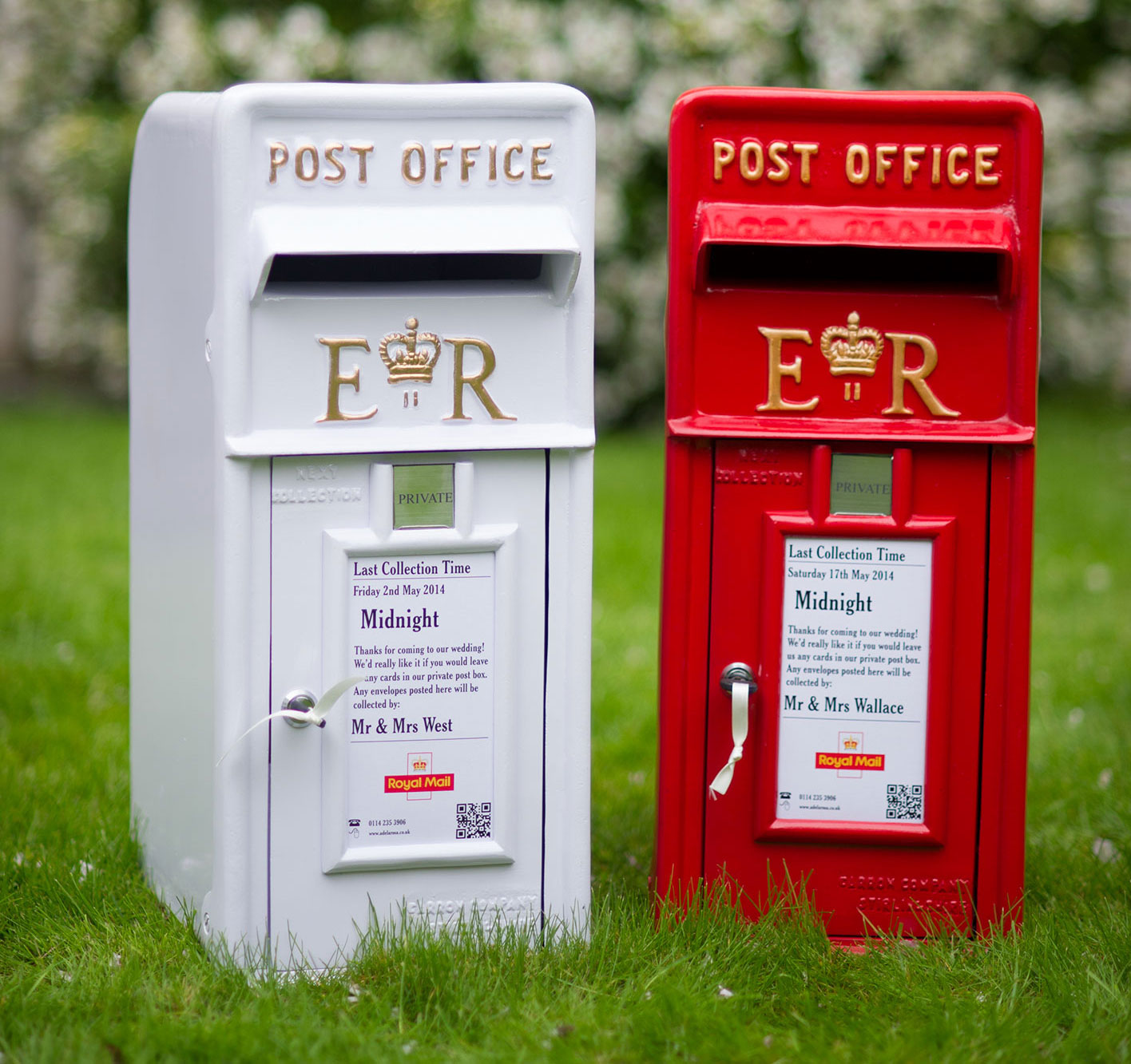Two traditional Wedding Postboxes, one red and one white, positioned on the grass at a recent Wedding.