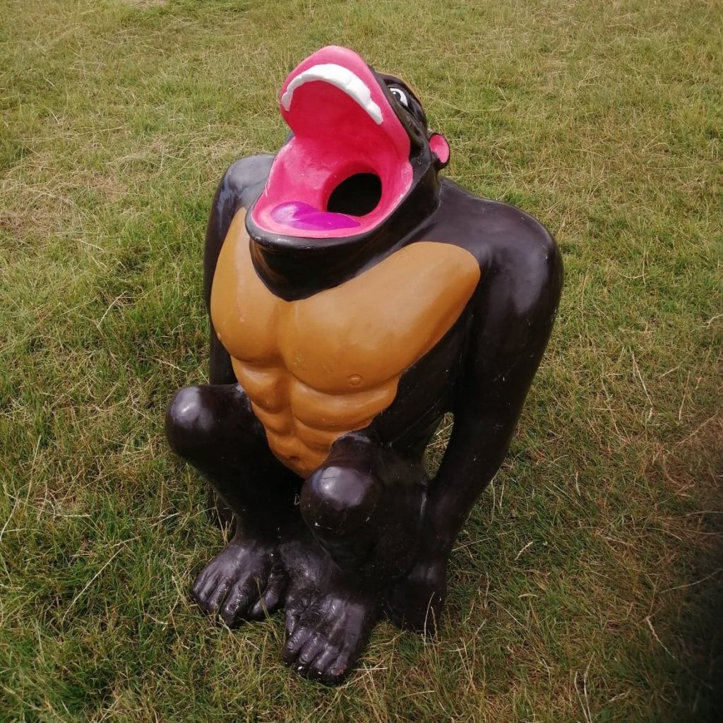 Our infamous Gorilla Golf Putt Challenge with Crazy Golf in the background, decorated with brightly coloured bunting and happy, focused children playing.