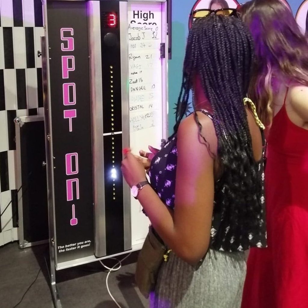 A female student having a go at our Spot On Reaction game at a University's Freshers Fayre event.