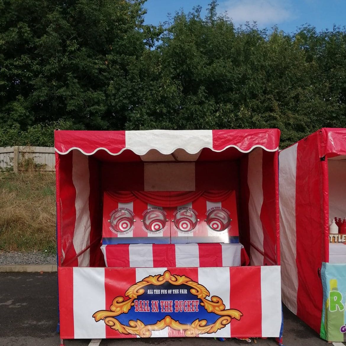 Our bright red and white striped Fete Game Side Stall set up with the Ball in Bucket game.