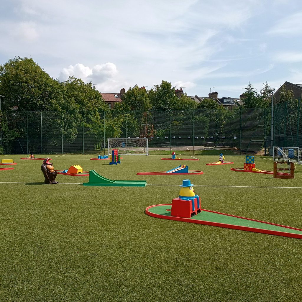 A summer day event with blue skies, green grass, Crazy Golf and our famous Gorilla Golf Putt Challenge game, taking centre stage with our Crazy Golf course all around.
