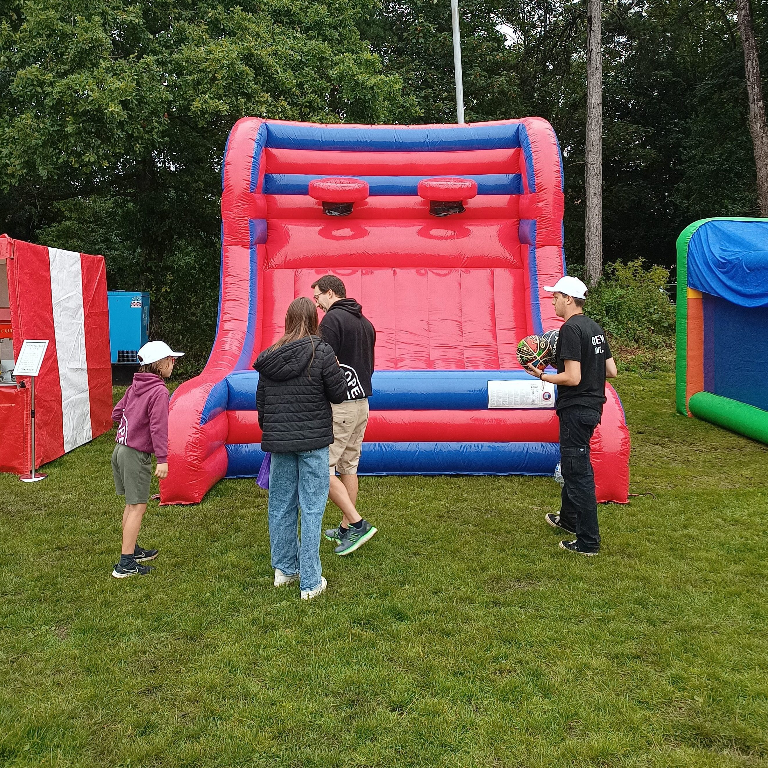 Group of teenagers about to play on the inflatable basketball at a college event