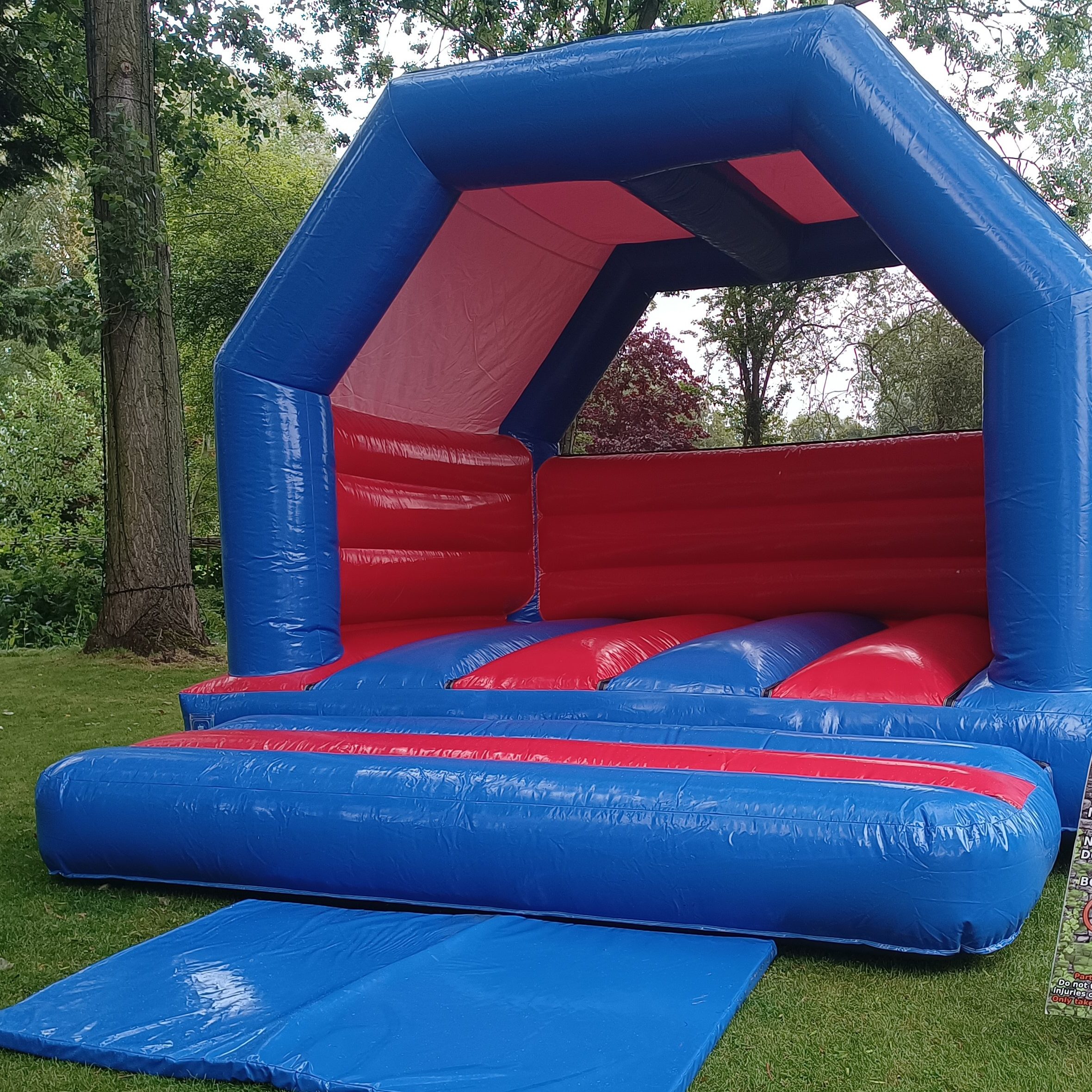Our red and blue Children's Bouncy Castle hired and set up ready for a Birthday Party event.