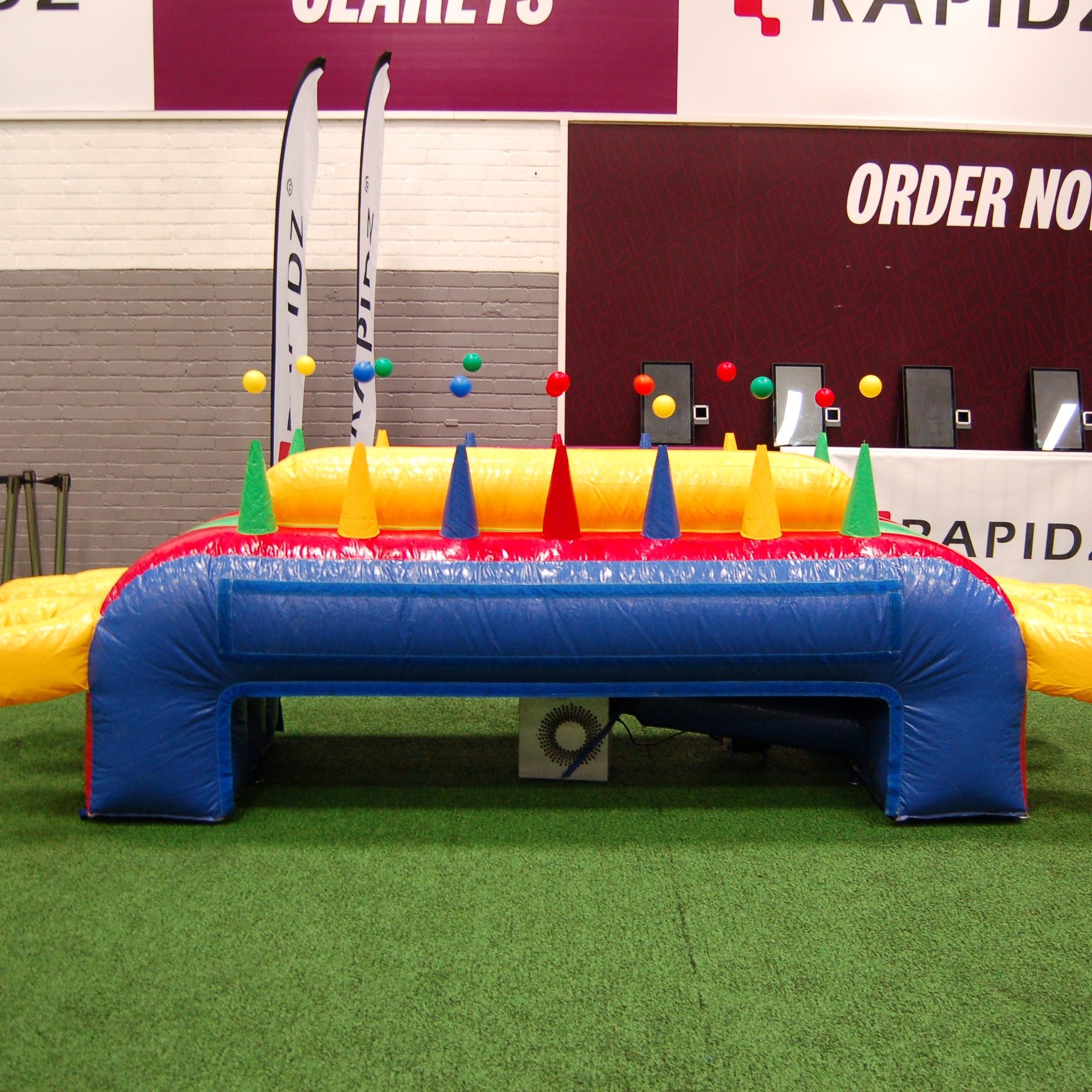 Our Inflatable Hoverboard at an indoor gym event with a blower in action so all balls are magically in the air.