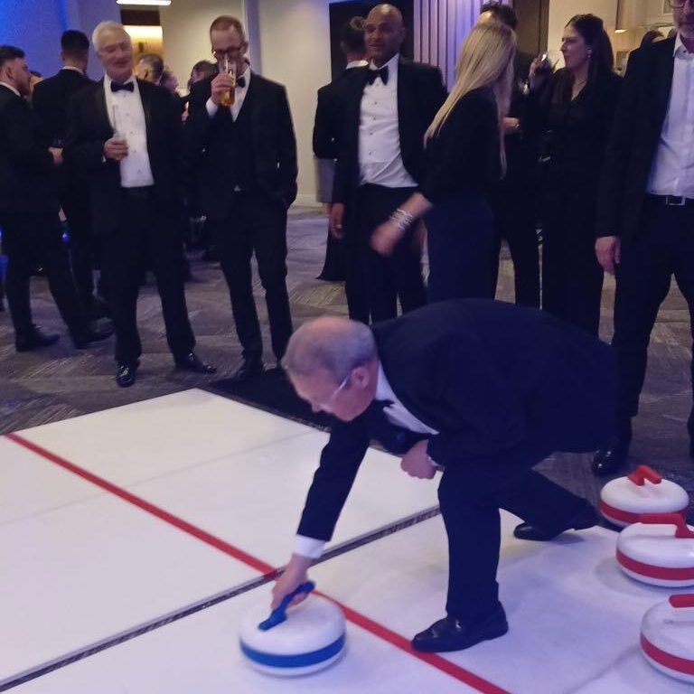 Our Big Impact Curling lane for hire with office workers enjoying a go.