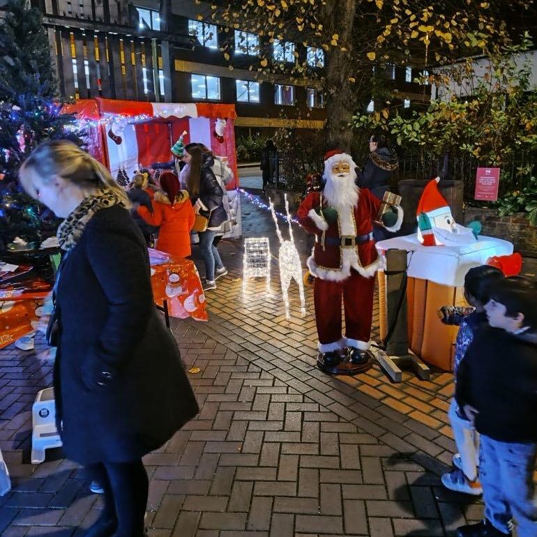 Our Festive Side Stalls hired with Christmas decorations at a recent Christmas Market event, with lots of people in view.