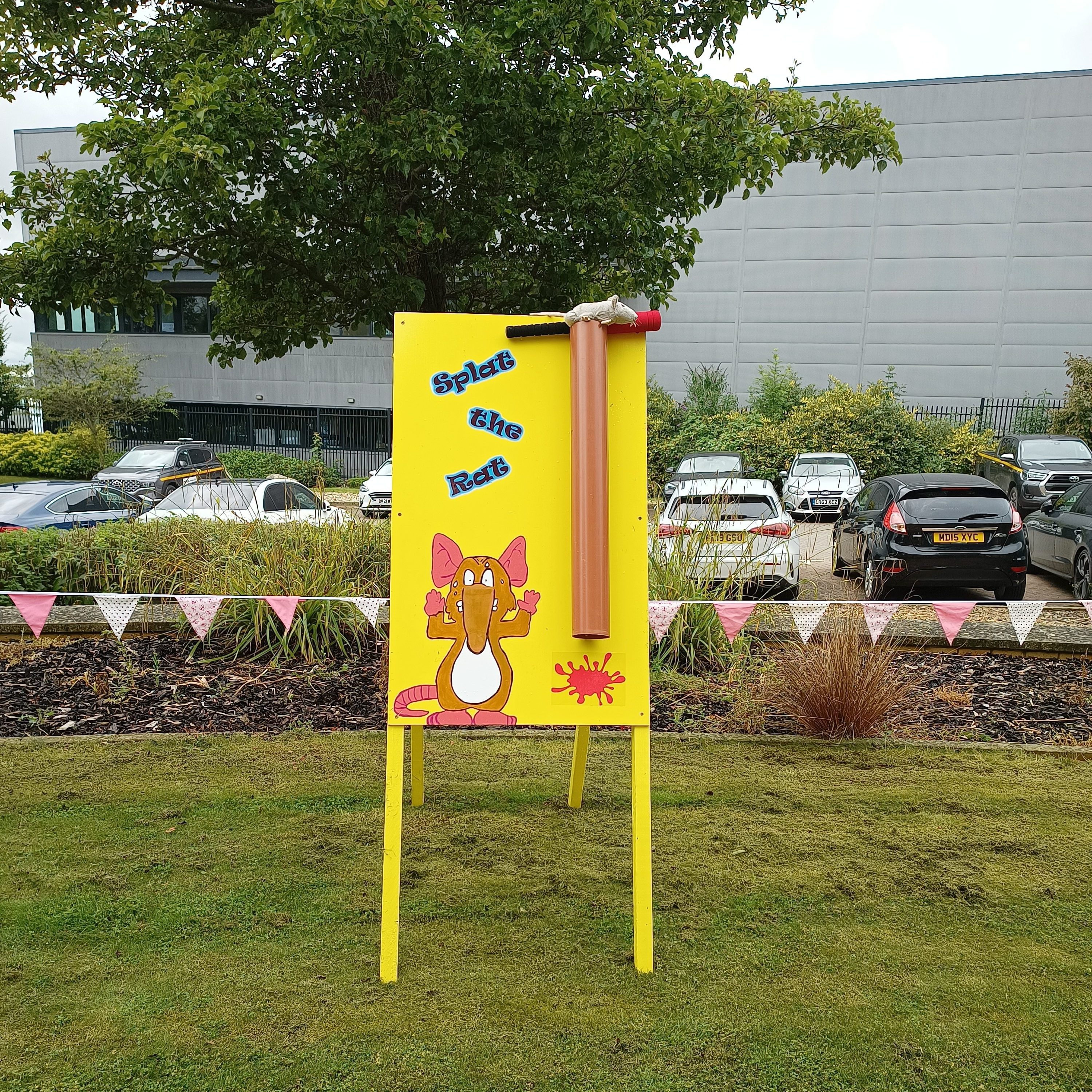 Our unique Splat the Rat with its bright yellow board, gutter pipe, bat, soft rat and an image of a cute rat with its hands up.