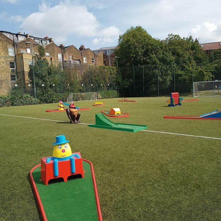 A summer day event with blue skies, green grass, Crazy Golf and our famous Gorilla Golf Putt Challenge game, taking centre stage with our Crazy Golf course all around.