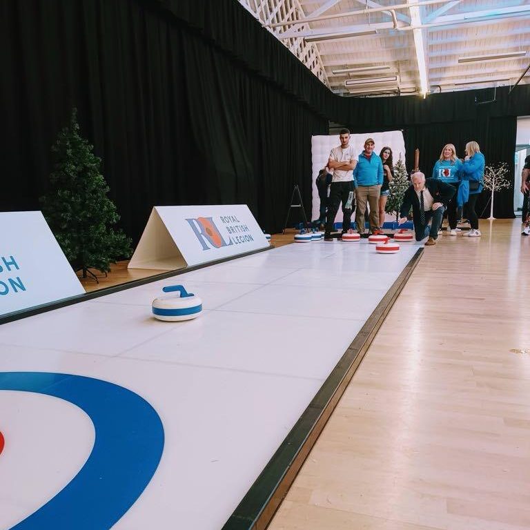 Our Big Impact Curling lane for hire with office workers enjoying a go.