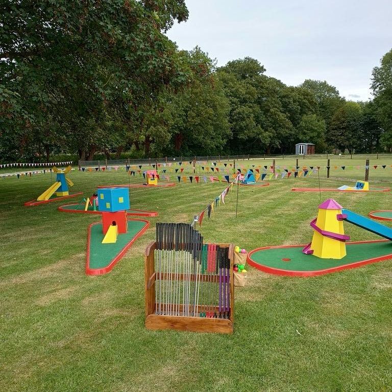 A snapshot of a School Fete with Crazy Golf and bunting set up ready.