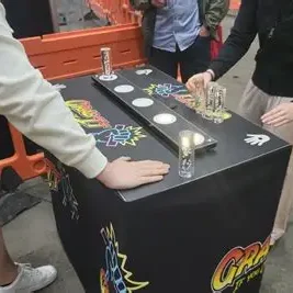 Adults at an Indoor Office Fun Day positioned ready for the Grab it speed reaction game to start