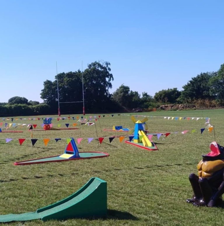 A summer day event with blue skies, green grass, Crazy Golf and our famous Gorilla Golf Putt Challenge game.