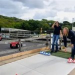 Two young girls enjoying a game of Curling purchased from us for a Dinosaur Park in the UK.