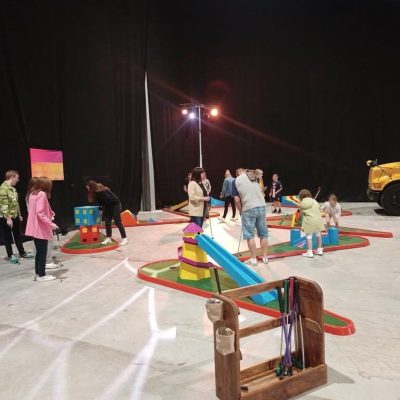 Crazy Golf hired and set up for an indoor event with our bespoke wooden holder for the golf clubs and golf balls.