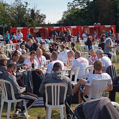 A huge crowd of people at a large village fete with 6 of our hired Fete Game Side Stalls towards the back.