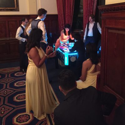 bride, groom and wedding guest at a hotel evening reception with electronic and tabletop games