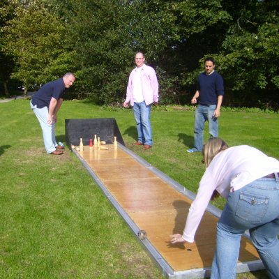 A group of people enjoying our game of Skittle Alley.